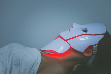 woman  with led light therapy facial and neck  beauty mask photon therapy