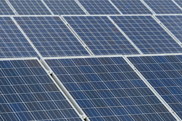 Solar panels close up on a cloudy day in Normandy, France. Solar energy, modern electric power production technology, renewable energy concept. Environmentally friendly electricity production