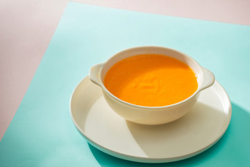 Carrot baby puree in bowl isolated on light background