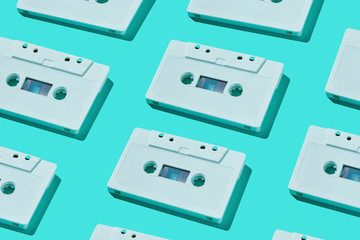 Pattern of audio cassette. Vintage white audio cassette tap on colored background. Old cassette tape audio isolated.