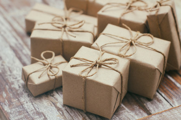 Set of parcel wrapped in craft paper and tie hemp cord. Delivery service. Online shipping. Decorative wooden background. Christmas presents concept. Many gifts.