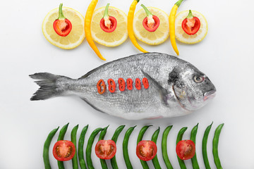 Composition with fresh dorado fish on white background
