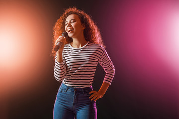 Beautiful African-American female singer with microphone on stage