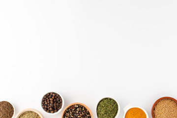 Overhead shot of seasonings in bowls isolated on white background with copyspace