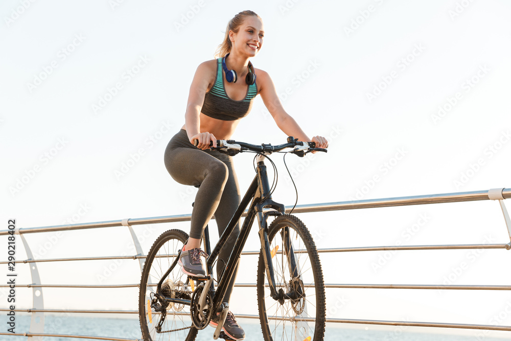 Canvas Prints Beautiful young fitness woman cyclist wearing