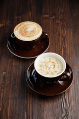 Cappuccino on a brown wooden background. Menu
