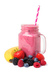 Berry mix smoothie  with banana and fresh ingredients in a glass jar on a white background