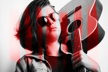 Obraz premium Portrait of a teenager with guitar in studio.