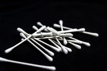 Several cotton swabs in macro on a black background