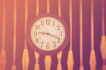 Clock hanging on wall background. 