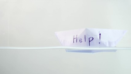 Folded paper boat floating on the water surface. Mental state and Emotional concept.