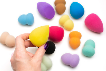 Woman's hand holding beauty blender