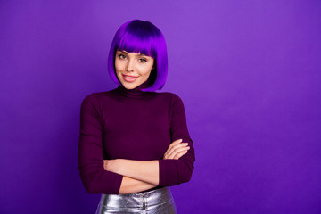 Portrait of pretty woman with her arms crossed looking smiling wearing turtleneck isolated over...