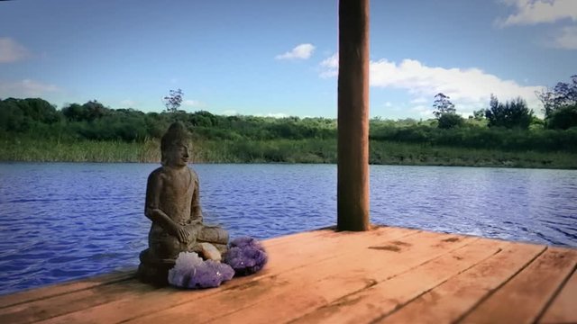 Buddha sitting on a pier