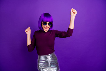 Portrait of cheerful lady with raised fists screaming yeah wearing eyeglasses eyewear isolated over...