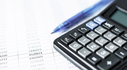 Calculator on white paper with numbers. Business and Finance accounting concept.