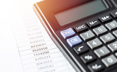 Calculator on white paper with numbers. Business and Finance accounting concept.