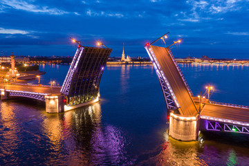 Fototapeta na wymiar Russia. Saint-Petersburg. Rivers Of St. Petersburg. Bridges Of St. Petersburg. Divorced Palace bridge. Neva river in the evening. Panorama of the evening city from a height.