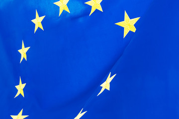 Political relationships. Flag of European Union. Close-up with yellow stars and blue color.