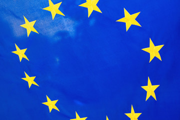 Political relationships. Flag of European Union. Close-up with yellow stars and blue color.