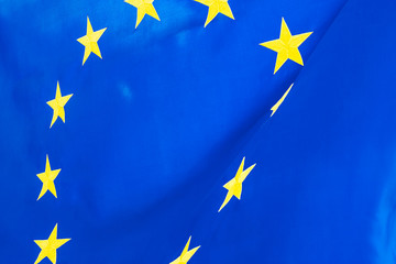 Political relationships. Flag of European Union. Close-up with yellow stars and blue color.