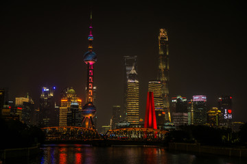 Obraz premium A Beautiful night around the Bund area in Shanghai city , this viewpoint offers the best spot for watching the spectacular skyline of this massive city with the most famous shanghai tower.