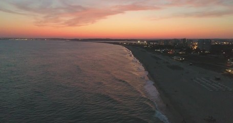 Aerial dusk view of Praia dos Tres Irmaos (Three Brothers beach) in Alvor, famous tourist destination in Western Algarve Coast, Portugal.