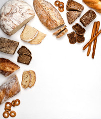 Different types of bread on a white background. Top view. Copy space.