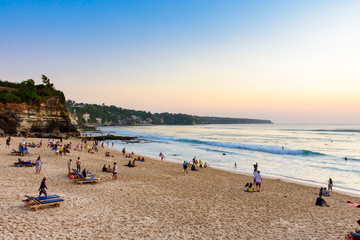 Dreamland Beach, Bali, Indonesia : 14th September 2019 - Tourists enjoying the sunset at one of Bali's most popular beaches