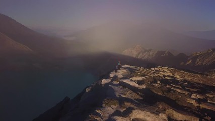 Aerial: People walking on the edge of crater  Kawah Ijen volcano, East Java, Indonesia