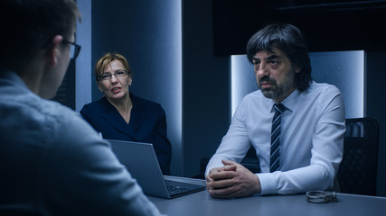 On a Job Interview Two Hiring Managers Ask Young Candidate Questions. Secret Service Recruiting Talented Young Man. Serious People Working in Government Agency.