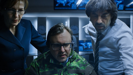 Military Dispatcher Wearing Headset Talks with Homeland Security Officials in the System Control / Monitoring Room. Joint Secret Operation of Military and Government Intelligence.