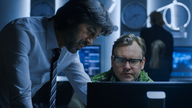 Government Chief of Cyber Security Agent Consults Military Officer who Works on Computer. Specialists Working on Computers in System Control Room.