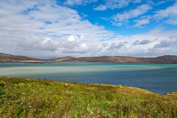 Looking out at the coastline and turquoise ocean, on the Hebridean island of Eriskay
