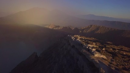 Aerial: People walking on the edge of crater  Kawah Ijen volcano, East Java, Indonesia