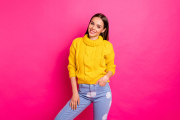 Portrait of lovely girl looking smiling wearing knitted pullover isolated over pink background