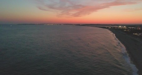 Aerial dusk view of Praia dos Tres Irmaos (Three Brothers beach) in Alvor, famous tourist destination in Western Algarve Coast, Portugal.