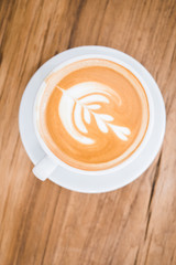 Top view of latte with wood background