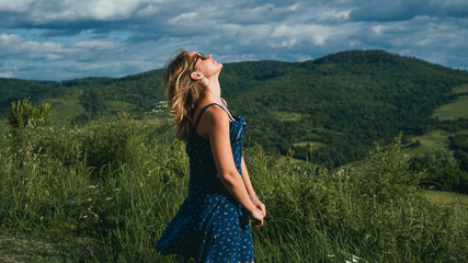 Woman in mountains at sunny day time. Beautiful natural mountain background. Ukraine, Carpathian mountains. Natural colors