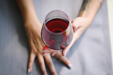 Girl holding a glass of red wine