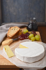 Camembert with grapes and wine, cheese plate