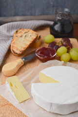 Camembert with grapes and wine, cheese plate