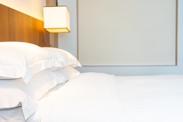 Fototapeta na wymiar White comfortable pillow on bed decoration