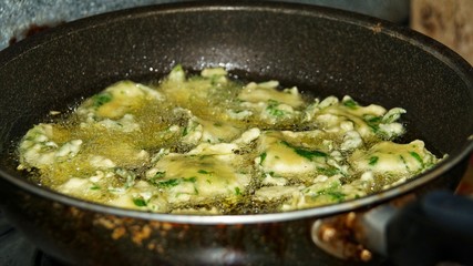 Cekodok frying in boiling oil. Popular traditional fritter snack also called jemput-jemput or cucur in Malaysia, Brunei and Indonesia.