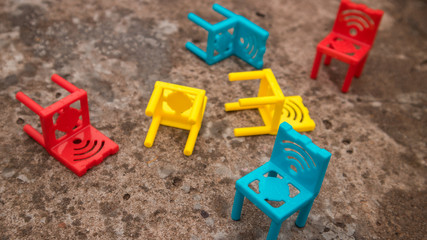 Fototapeta na wymiar Multi-colored chairs on a concrete floor