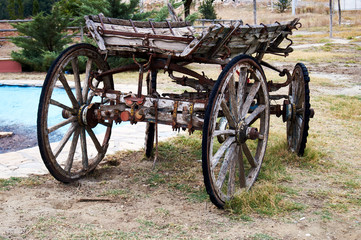 Old wooden cart with four wheel on road