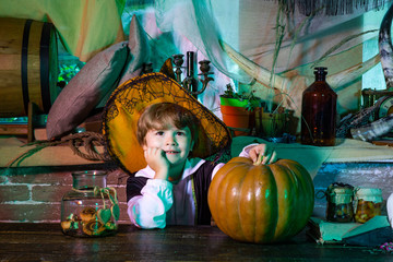 Cute child boy wearing Halloween costumes having fun on Halloween celebration. Happy Halloween. Funny boy on Halloween party. Funny face.