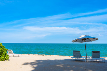Beautiful umbrella and chair around beach sea ocean with blue sky for travel