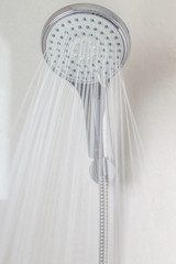 shower head in bathroom with water drops flowing