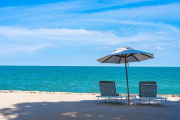 Beautiful umbrella and chair around beach sea ocean with blue sky for travel